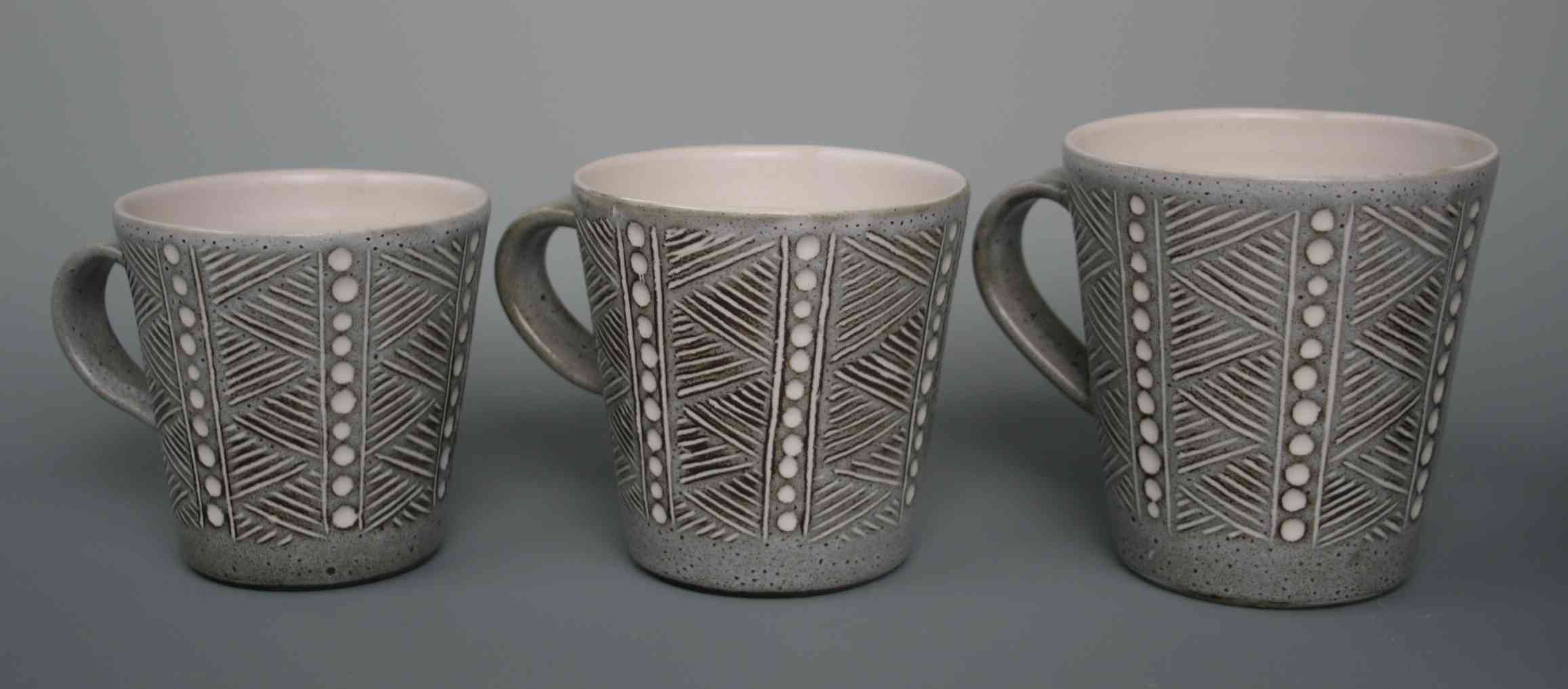 3 x white stoneware mugs with incised black slip and white glaze
